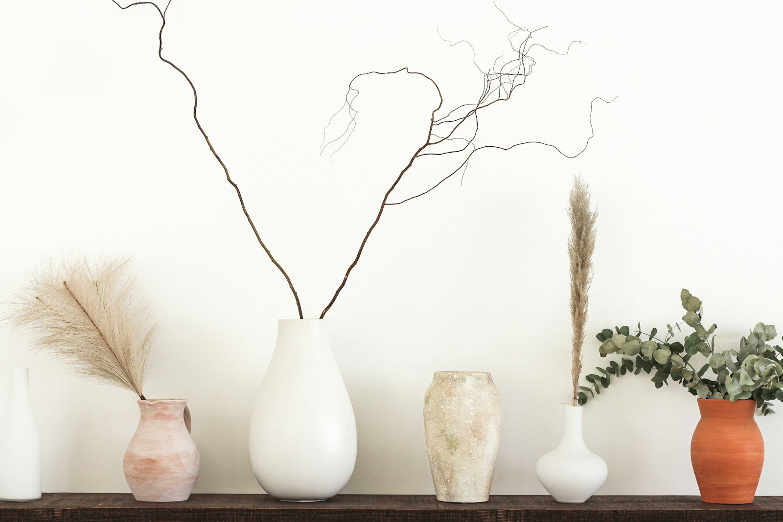 Ceramic vases and botanical details on a console